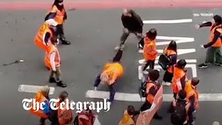 Just Stop Oil protester thrown to ground by enraged motorist [upl. by Sheng]