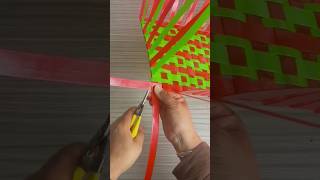 The process of weaving a basket from colored plastic ribbons [upl. by Mcloughlin]