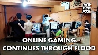 Online gaming addicts in cafe continue playing through typhoon flood  New York Post [upl. by Anwahsed]