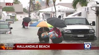 Residents wade through flood waters in Hallandale Beach [upl. by Arda]