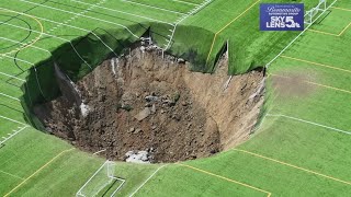 Surveillance video shows moment when 100footwide sinkhole swallows Alton Illinois soccer field [upl. by Ittam649]