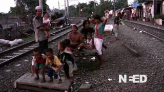 Daily life in a shantytown by train tracks Jakarta Indonesia [upl. by Aisenat340]