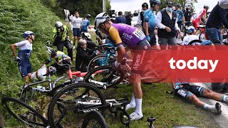 Spectator with signboard causes massive crash at Tour de France [upl. by Yhotmit]