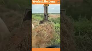 An excavator with a bladed bucket clears debris restoring a concrete walkway swiftly [upl. by Vanhomrigh]