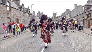 Chieftain leads the massed Pipes and Drums on the march to 2023 Dufftown Highland Games in Scotland [upl. by Doowron804]