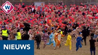 Nieuwjaarsduik 2019 Duizenden rennen naar de zee  OMROEP WEST [upl. by Gad]