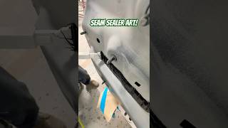 Laying seam sealer on this BMW after replacing the rear body panel seamsealer autobody collision [upl. by Atwahs]