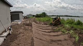 Skid steer grading on a slope [upl. by Onitsirc]