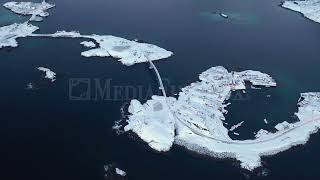 Stock Video  Aerial view of Hamnoy bridge in Reine Norway during winter [upl. by Annaillil]