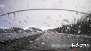 Car skids backwards on motorway during severe weather narrowly avoiding traffic officer [upl. by Clementas218]