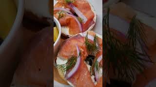 Bagels cream cheese salmon and herbs serve with slice fresh fruits at today Cafe [upl. by Kane]