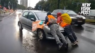 Irate drivers ram into climate protesters blocking traffic drag them hundreds of feet down highway [upl. by Gninnahc]