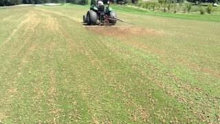 Golf Course fairway aeration  dragging the cores to incorporate seed [upl. by Rostand]