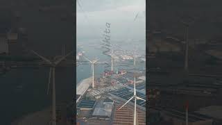 Vertical video Antwerp Belgium Port infrastructure with docks and factories Wind power plants [upl. by Gonagle]