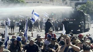 Israeli police use a water cannon to disperse protesters blocking road to parliament  AFP [upl. by Aivatan683]