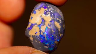 See what’s inside this uncut gem  A world of color  black opal [upl. by Esiled]