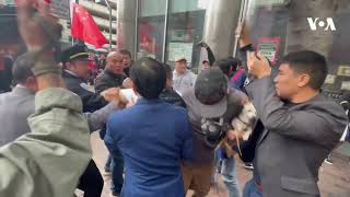 Supporters and Protesters of China Clash During APEC Forum  VOA News [upl. by Nnaeirelav]