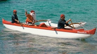 Santa Canoe Surfs into Waikiki Hawaii for Christmas Menehune Style [upl. by Palmore]