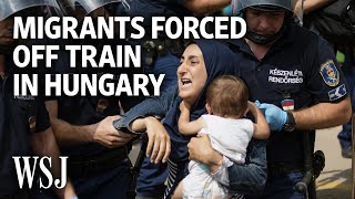 Armed Police Force Migrants Off Train in Hungary  WSJ [upl. by Kathe]