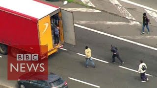 Moment Calais migrants jumped onboard lorries  BBC News [upl. by Nolyak131]