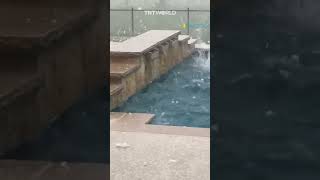 Large hailstones splash on pool water as Texas hit by severe storms [upl. by Arateehc]