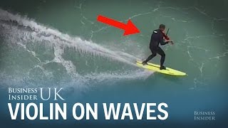 A musician played the violin while surfing milehigh waves in Portugal [upl. by Nawd146]