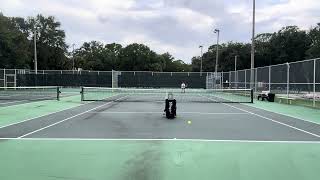 Hitting off the Slinger Tennis ball machine in 20mph winds trying to hit left handed [upl. by Neomah]