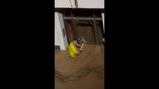 Man smashes glass door to save children in Spanish floods [upl. by Bowers]