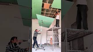 The process of installing plasterboard on the ceiling using a hoist [upl. by Lilian]