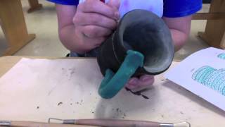 Underglazing a greenware mug and adding sgraffito designs [upl. by Jac123]